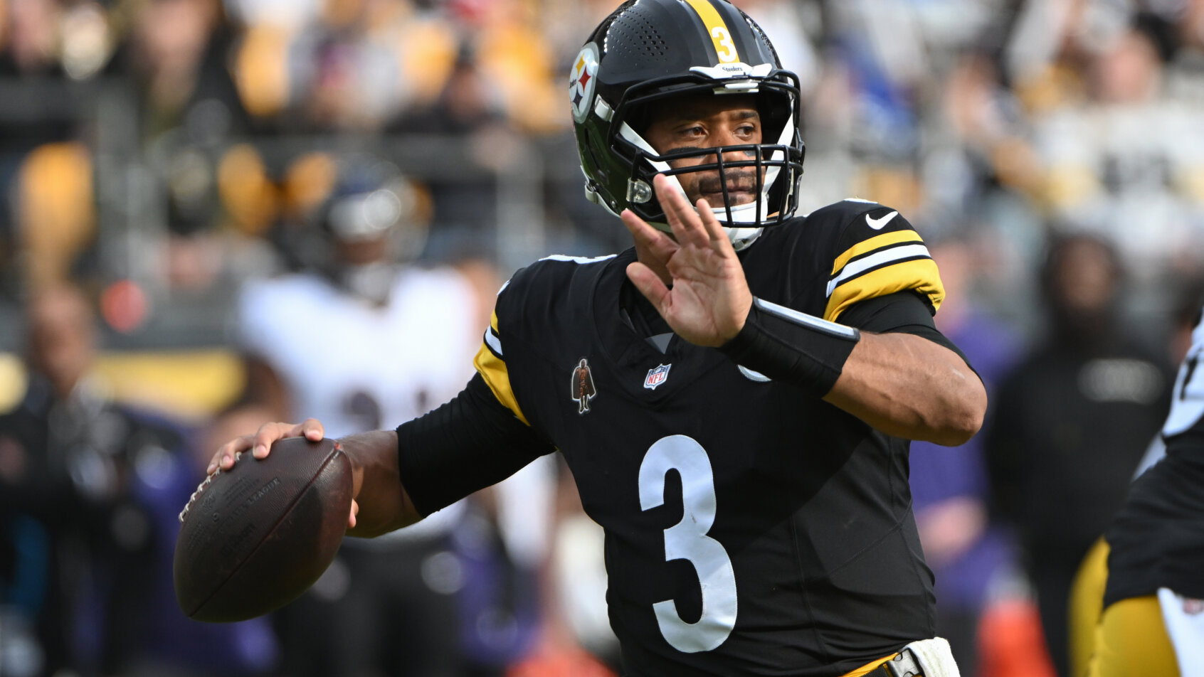 Pittsburgh Steelers player Russell Wilson throwing a football.